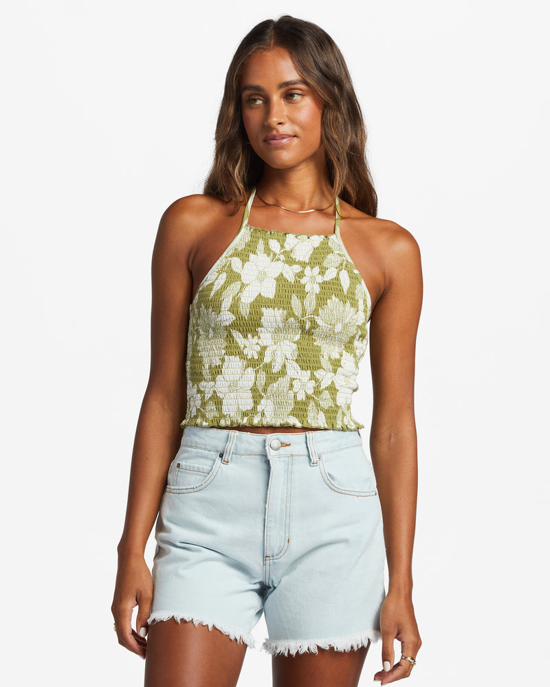 shows front view of fully smocked crop top featuring an adjustable halter neck tie and lettuce hems.