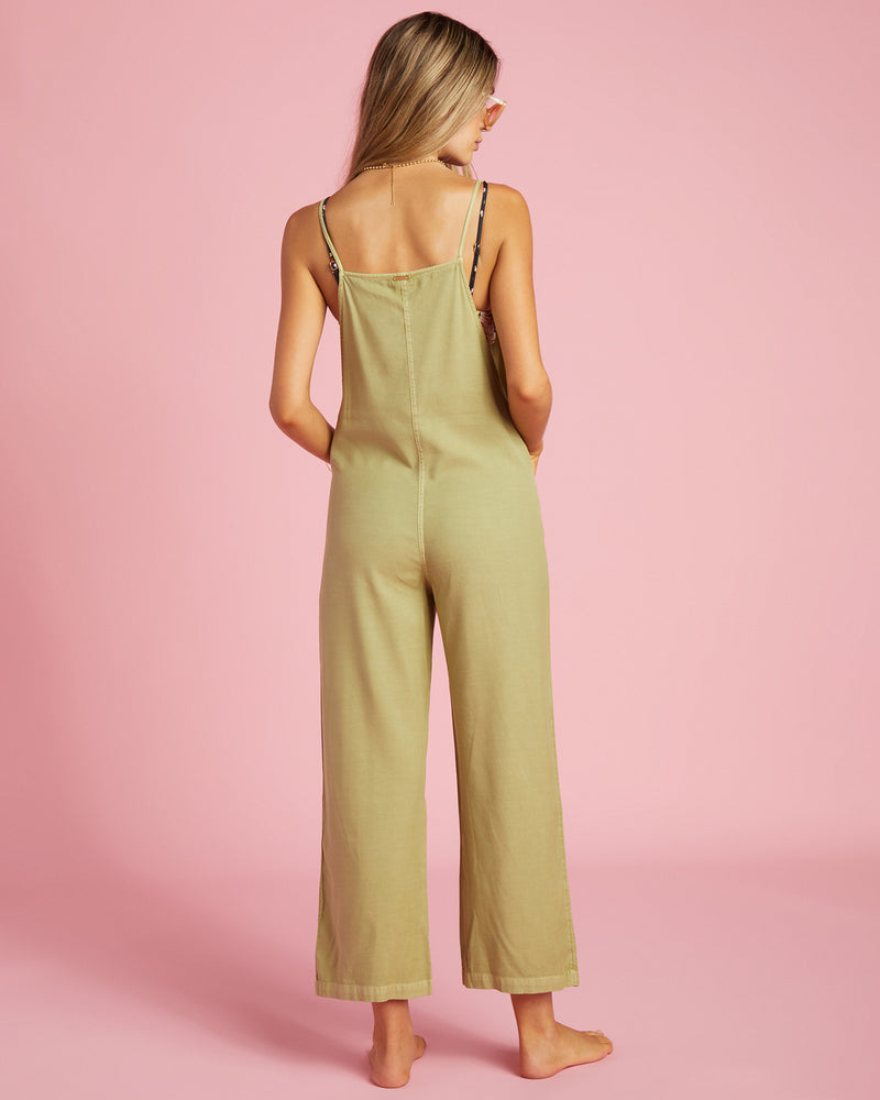 shows back view of overalls featuring a center seam, metal plaque reading "billabong" 