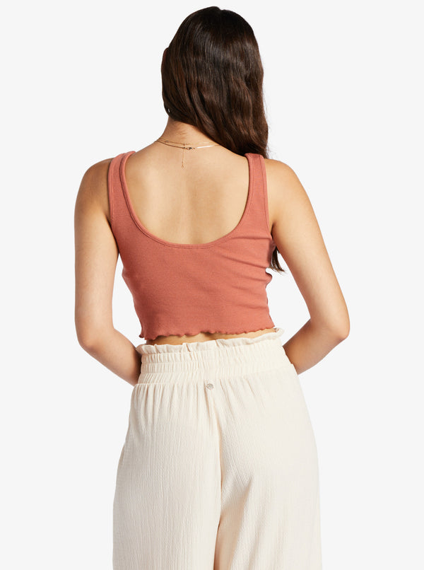 shows the back view of model in the redwood  tank. shows a low scoop back and lettuce edge hem.