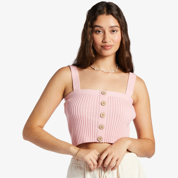 shows front view of model in top. shows the sweater material, thick straps and buttons down the front.